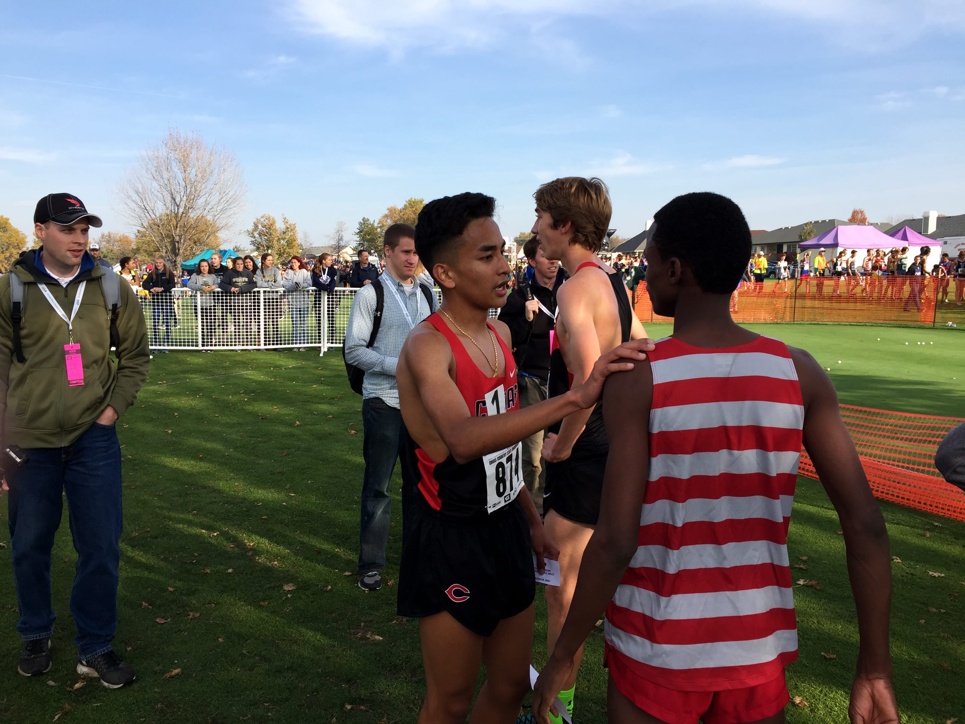 Yacine Guermali of Camas talks with fellow runners after he won the Class 4A race at the State Cross Country Championships on Saturday in Pasco.