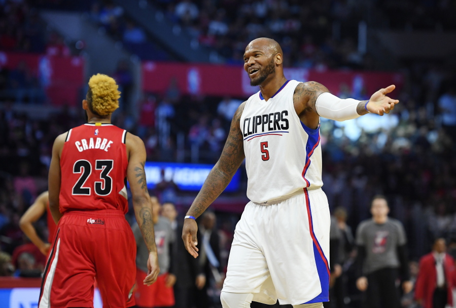 Los Angeles Clippers center Marreese Speights, right, tries to fire up the crowd as Portland Trail Blazers guard Allen Crabbe walks away during the first half of an NBA basketball game Wednesday, Nov. 9, 2016, in Los Angeles. (AP Photo/Mark J.