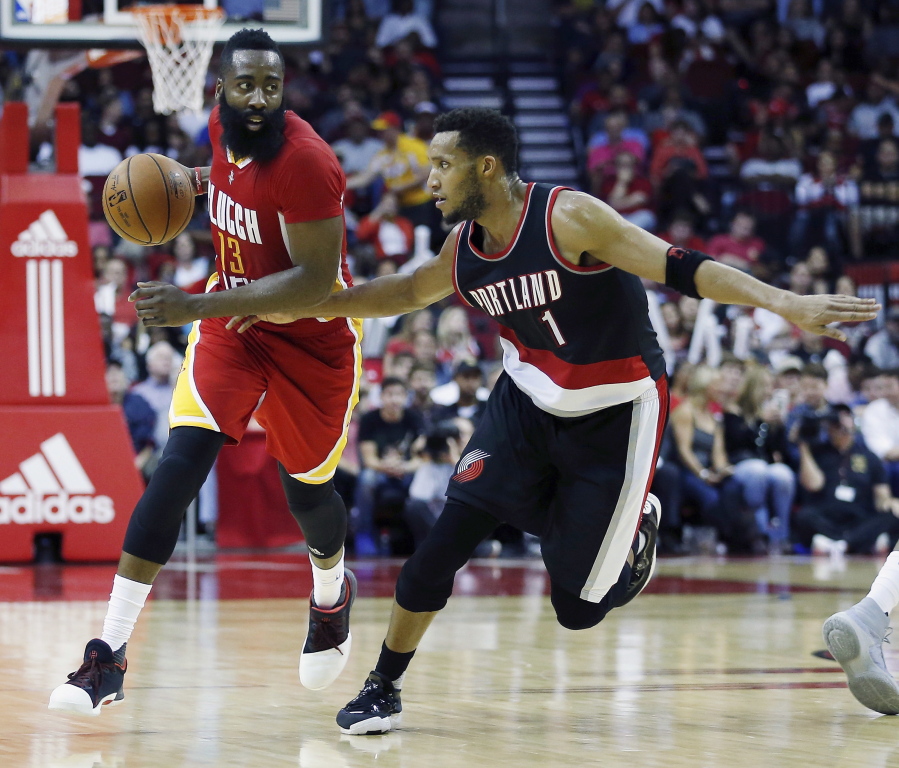 Houston Rockets guard James Harden (13) brings the ball up the court as he is defended by Portland Trail Blazers guard Evan Turner (1) in the second half of an NBA basketball game on Thursday, Nov. 17, 2016, in Houston.