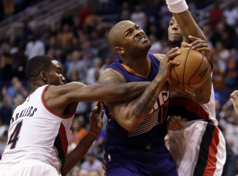 Phoenix Suns forward P.J. Tucker is fouled by Portland Trail Blazers forward Maurice Harkless (4) during the second half of an NBA basketball game, Wednesday, Nov. 2, 2016, in Phoenix. Phoenix defeated Portland 118-115 in overtime.