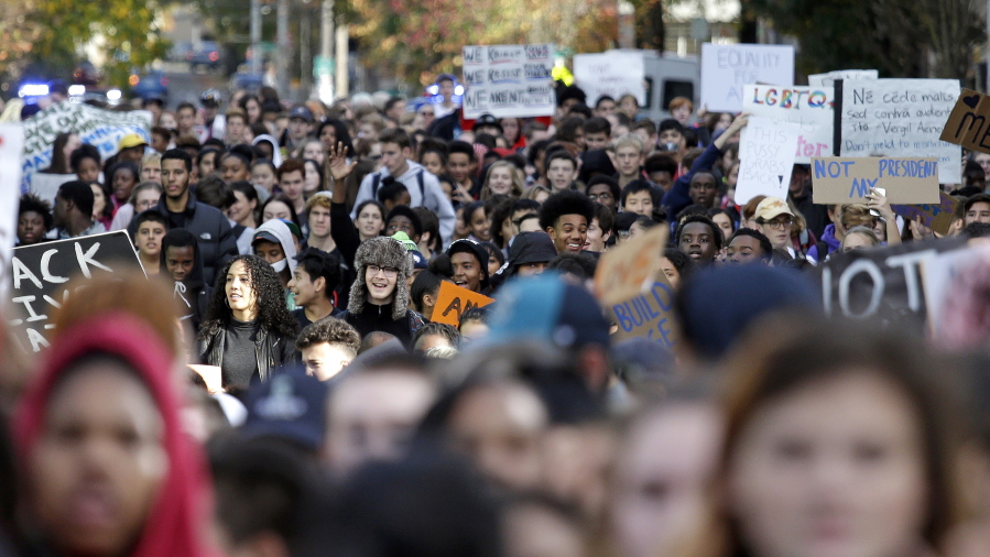 Seattle high school students head to join others during a walkout to protest the election of Donald Trump.