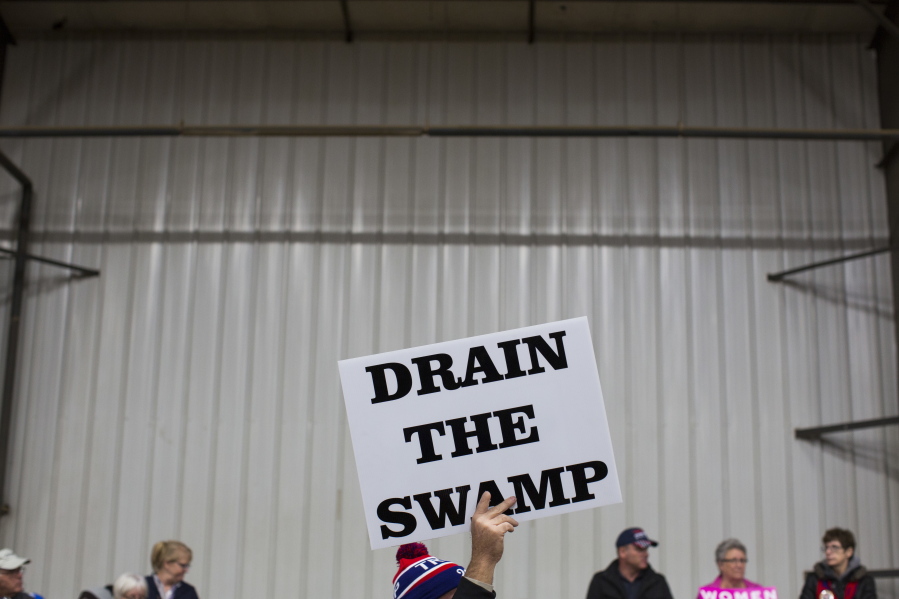 Supporters of then-Republican presidential candidate Donald Trump hold signs during a campaign rally in Springfield, Ohio.