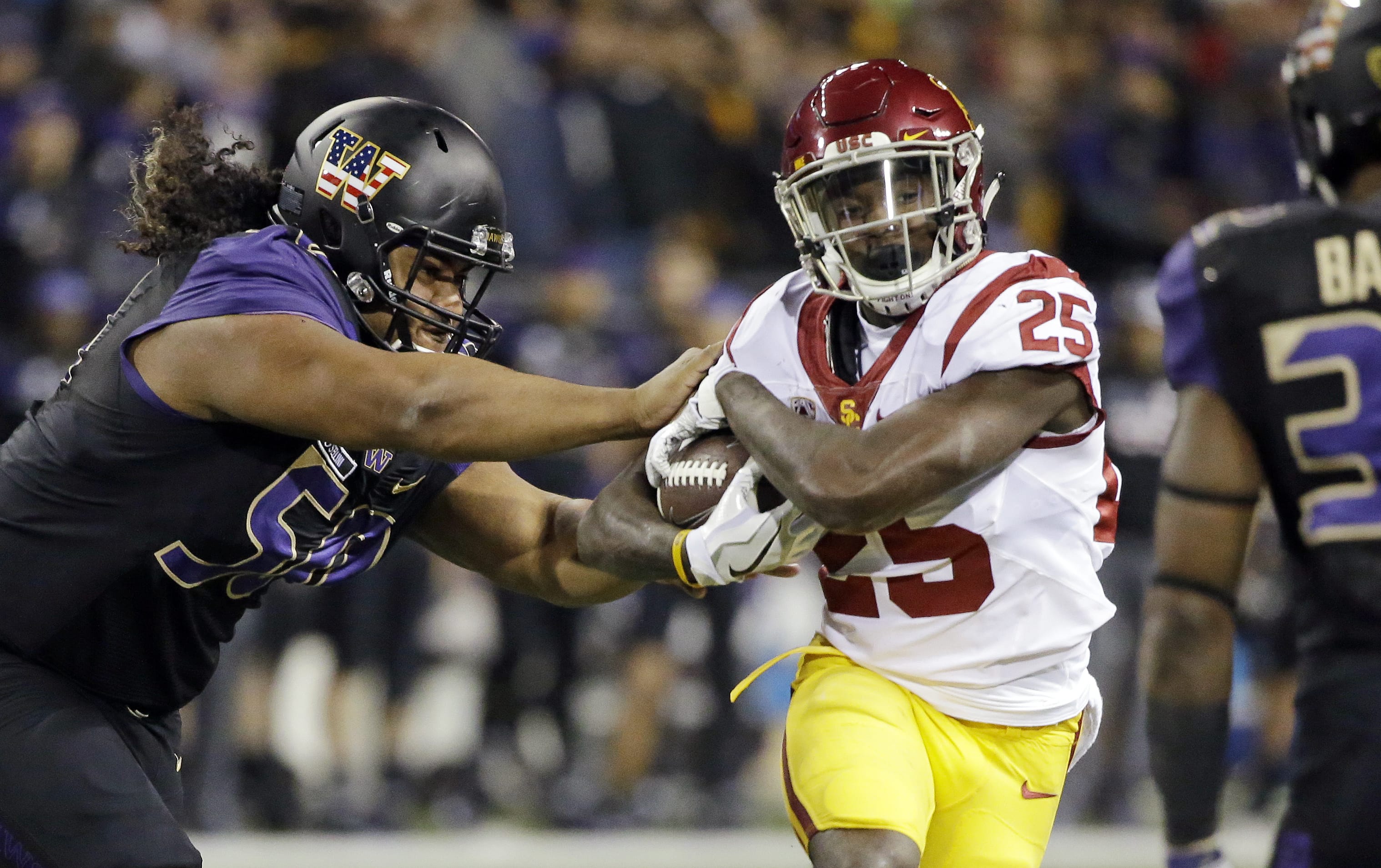Washington defensive lineman Vita Vea, left, pushes Southern California running back Ronald Jones II on a carry by Jones in the first half of an NCAA college football game Saturday, Nov. 12, 2016, in Seattle.
