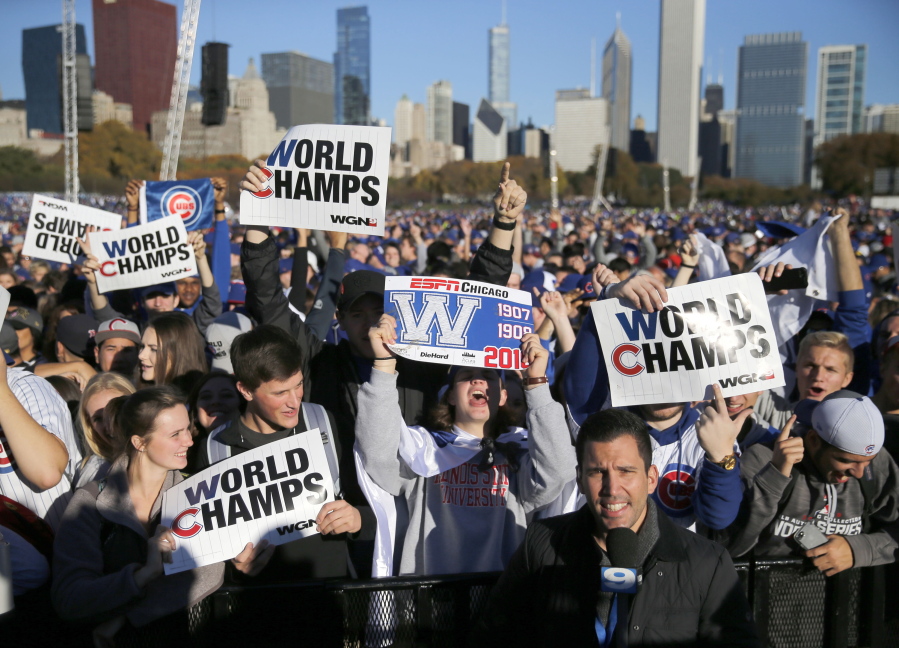 Chicago Cubs fans celebrate Friday before a rally in Grant Park honoring the World Series baseball champions in Chicago.