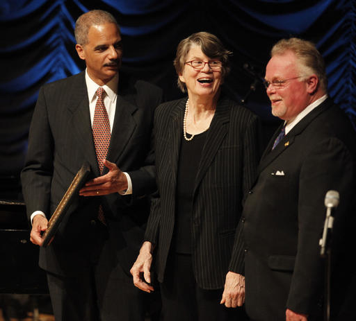 In this April 17, 2009, file photo, former Attorney General Janet Reno, center, is presented with the American Judicature Society 2009 Justice Award by Attorney General Eric Holder, left, during a ceremony at the Ronald Reagan Building and International Trade Center in Washington. Reno, the first woman to serve as U.S. attorney general and the epicenter of several political storms during the Clinton administration, has died early Monday, Nov. 7, 2016. She was 78. On the right is Kirk Noble Bloodsworth from the Justice Project.