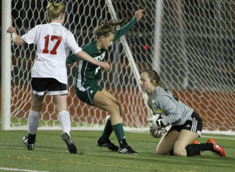 Camas Papermakers' goalie Julia Coombs, right, covers the ball against Skyline Spartans' Alli Schnebele (7) as Ashley Carter (17) defends in the WIAA 4A Semifinal Women's soccer match held Friday, November 18, 2016 at  Sparks Stadium in Puyallup, WA. The Papermakere beat the Spartans 1-0 to advance to the championship match which will be held at 4 PM at Sparks Stadium in Puyallup.