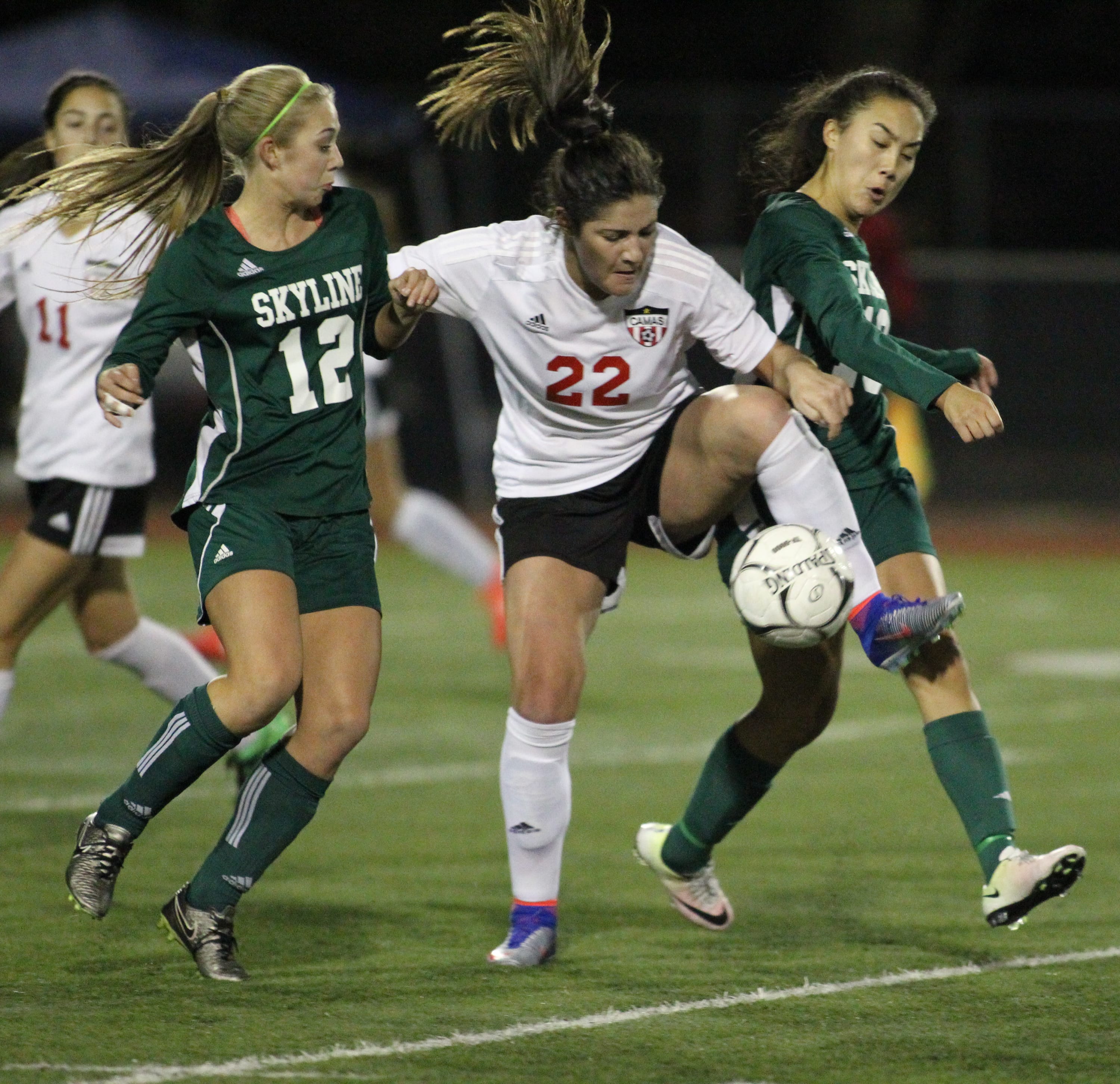 Camas Papermakers' Alyssa Tomasini (22) fighs for ball conrol with Skyline Spartans' Clare Wate (12) and Julia Mitchell (16)in the WIAA 4A Semifinal Women's soccer match held Friday, November 18, 2016 at  Sparks Stadium in Puyallup, WA. Tomasini kicked the winning goal in he 75th min to give the Papermakere a 1-0 win over the Spartans to advance to the championship match which will be held at 4 PM at Sparks Stadium in Puyallup.