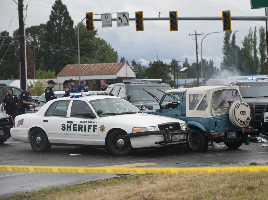 Police and emergency personnel respond to the scene of a deputy's shooting of a bank robbery suspect on June 13 west of Battle Ground. Kenneth Allen Pointer was shot by an officer after robbing a downtown Vancouver bank and fleeing the scene, according to police.