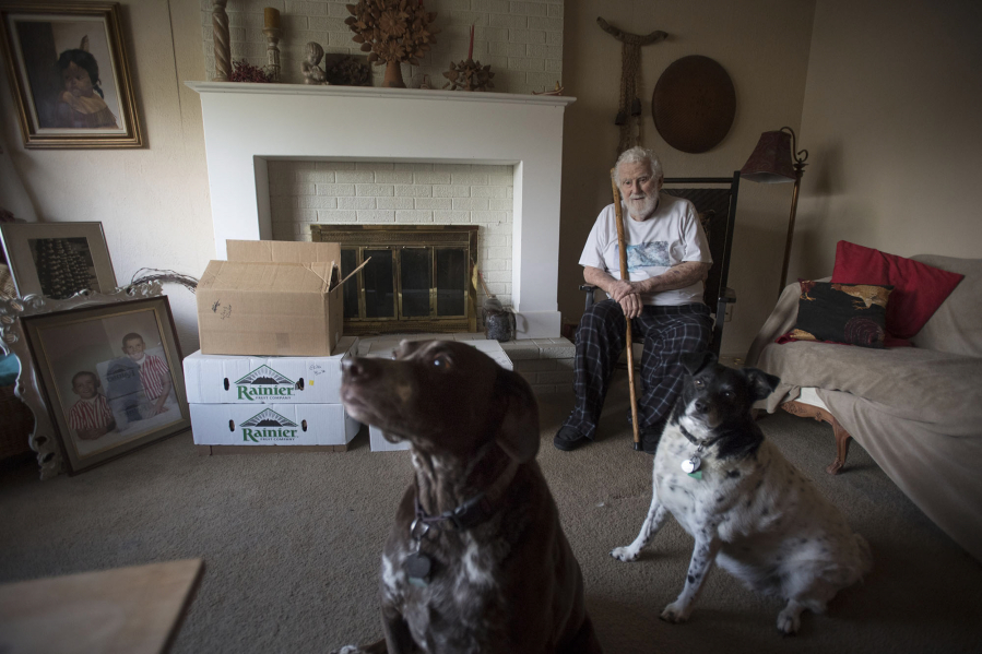 Orchards resident John Schumacher is pictured Wednesday at his home with his 10-year-old dogs Max, left, and Faith. Schumacher is preparing to move into an assisted living center and must find a new home for his dogs. A Salmon Creek man is interested in adopting the dogs.