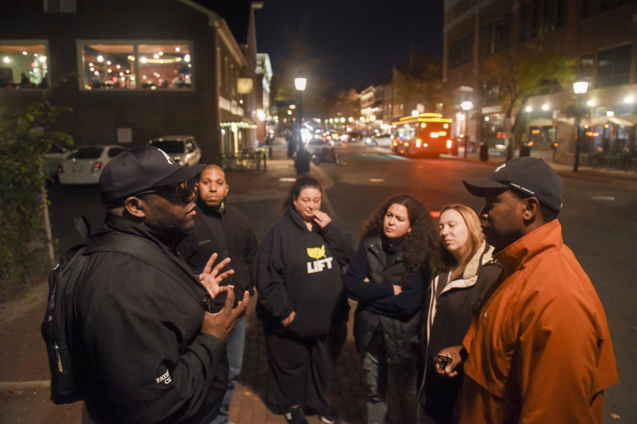 John Taylor Chapman, left, an Alexandria, Va., city council member and former head of the local NAACP, leads a black history tour on Nov. 13.