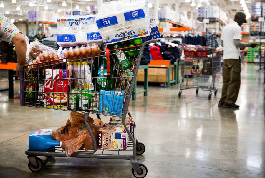 A customer stands by a shopping cart inside a Costco Wholesale Corp. store in Miami.