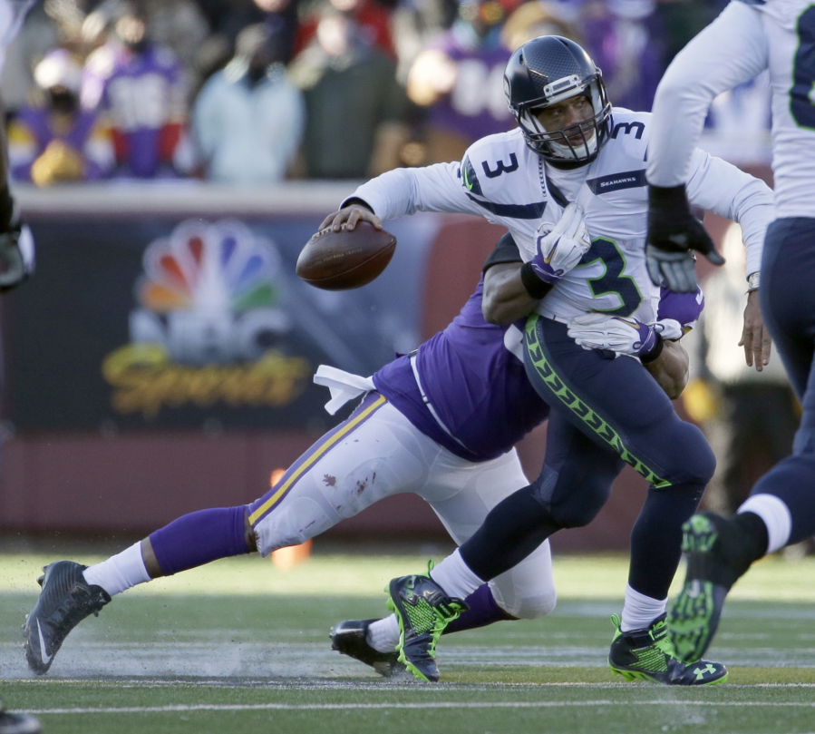 Vikings defensive end Everson Griffen (97) tackles as Seahawks quarterback Russell Wilson (3) during last season&#039;s wild-card playoff game in Minnesota. (Nam Y.