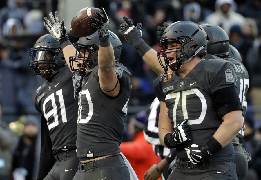 Army running back Andy Davidson (40) celebrates his touchdown with teammates in the first half of the Army-Navy NCAA college football game in Baltimore, Saturday, Dec. 10, 2016.