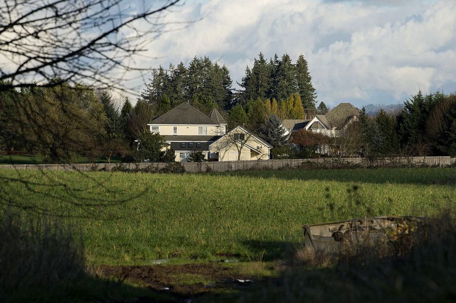Homes are seen beyond a field in Ridgefield on Dec. 6.  Nearby homeowners are entangled in a legal drama between a developer, homeowners&#039; association and the city of Ridgefield about what can be done with the vacant property.