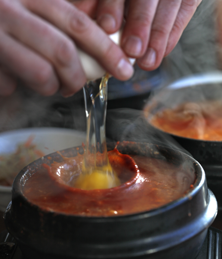 Diners traditionally crack an egg into their sundubu at the table, where it cooks in the soup/stew.