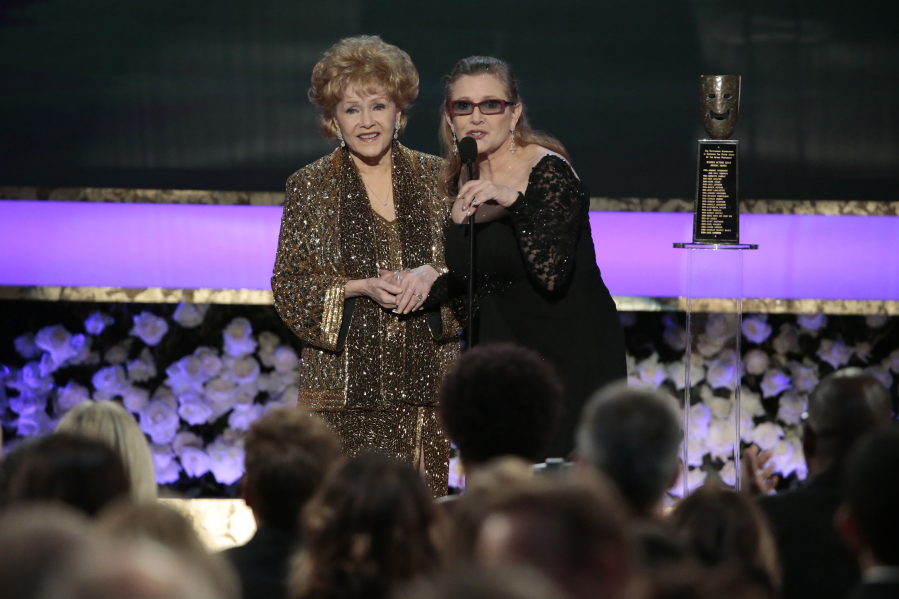 Carrie Fisher presents the Life Achievement Award to Debbie Reynolds at the 21st Annual Screen Actors Guild Awards on Sunday, Jan. 25, 2015, at the Shrine Auditorium in Los Angeles.