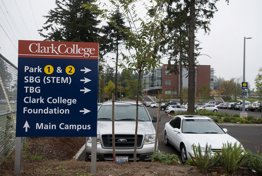 A sign at Clark College helps visitors in the fall find their way to places around campus including the new STEM Building, background.
