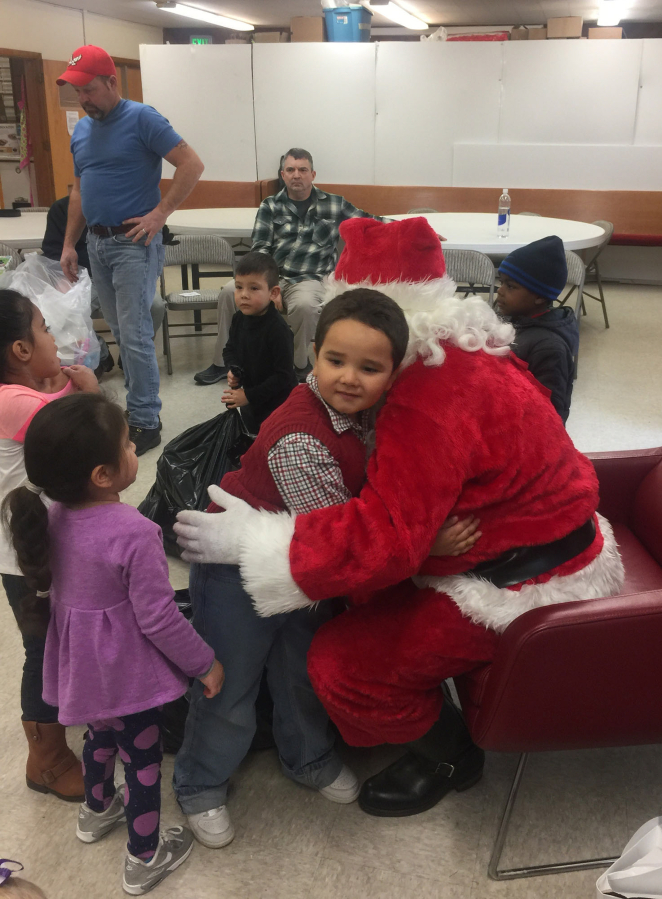 Evergreen Highlands: Bonneville Power Administration employees brought gifts and Santa to a visit at the Learning Avenues Child Care Center on Dec.