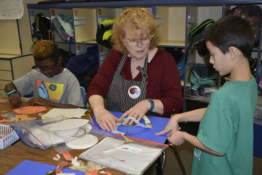 Washougal: Gause Elementary School&#039;s Peggy Ross works with students in art class while they create new animals as part of new curriculum to learn different animal classifications.