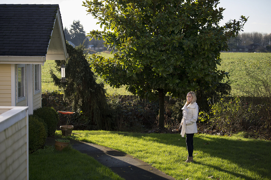 Kelly Smith is pictured in the backyard of her Ridgefield home as the fields of a neighboring farm are seen in the background.