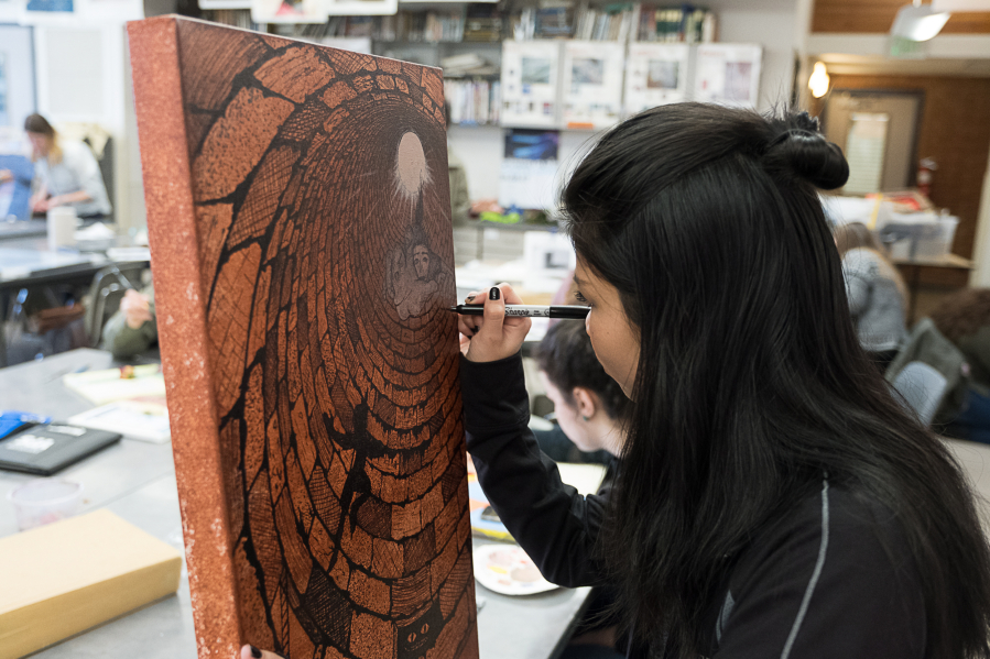 Columbia River High School art student Kimzaira Sotaridona, 16, finishes the detail work on her artwork Dec. 13.