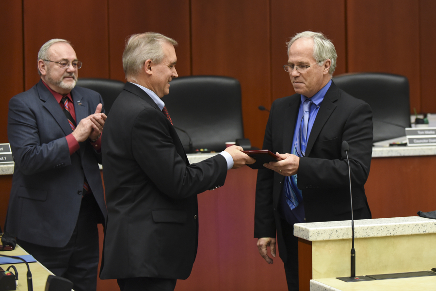 County Councilor David Madore accepts a plaque Tuesday from County Chair Marc Boldt acknowledging his work on the council at the last Clark County council hearing to include Madore and Councilor Tom Mielke on Tuesday.