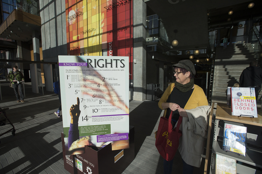 Vancouver resident Carmen Weninger looks over the Bill of Rights display at the Vancouver Community Library on Tuesday morning.