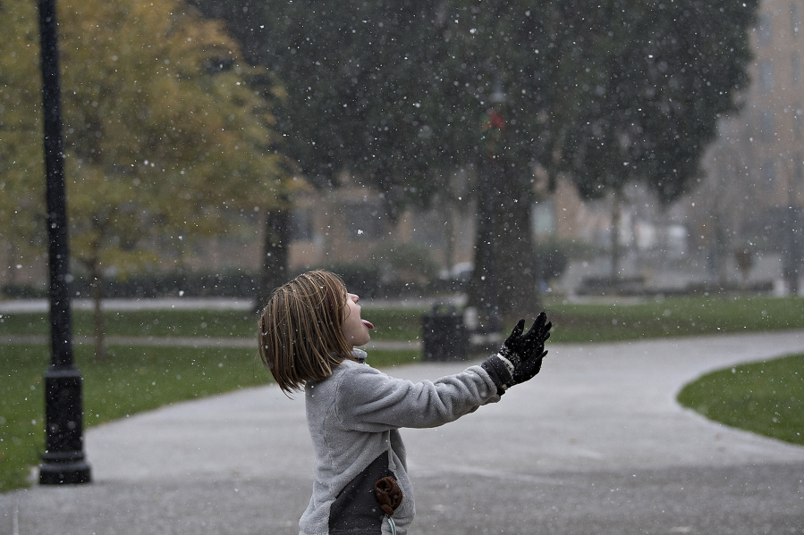 Delainey Poe of Vancouver catches snowflakes on her tongue in 2016 at Esther Short Park.
