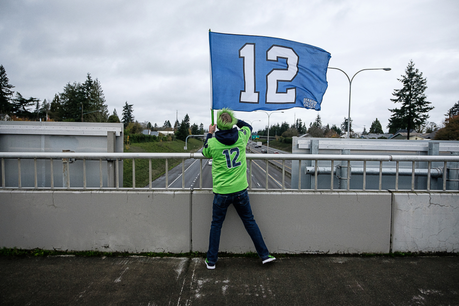Seattle Seahawks fan Mike Meherin waves a 12 flag on the 29th Street overpass of Interstate 5 in Vancouver on Nov. 27 before the afternoon football game. Meherin, who lives in Vancouver&#039;s Uptown Village, has been waving the flag from the overpass since 2012.