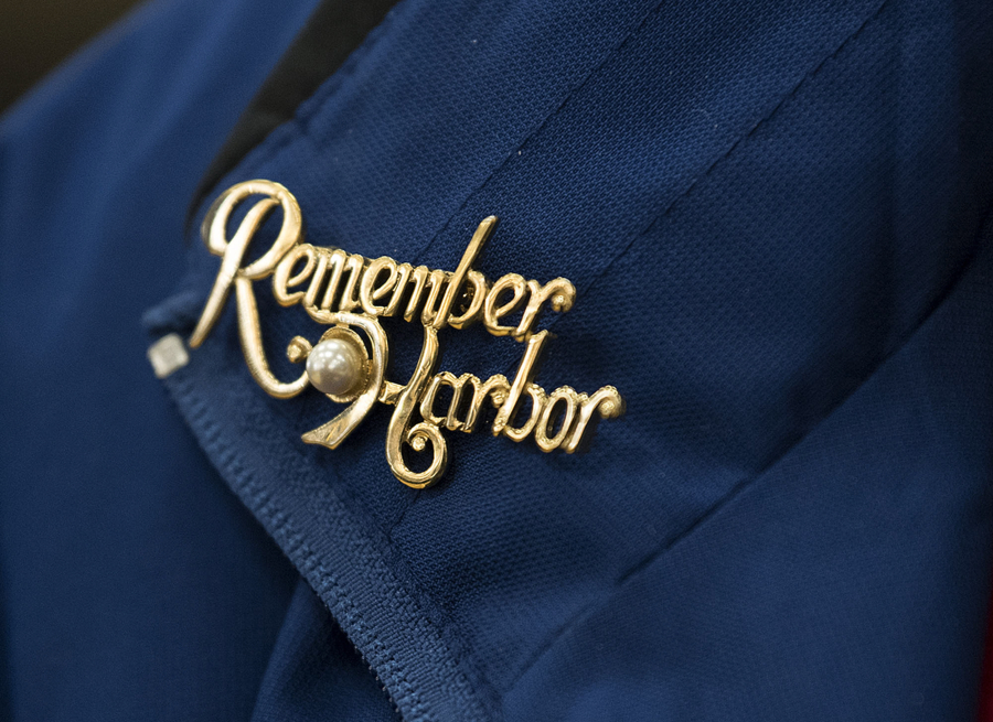 A Pearl Harbor remembrance pin on Clara Lacy&#039;s jacket honors the memory of her husband. Hal Lacy was a 17-year-old radioman aboard the USS Tennessee at Pearl Harbor; he died in 2013.