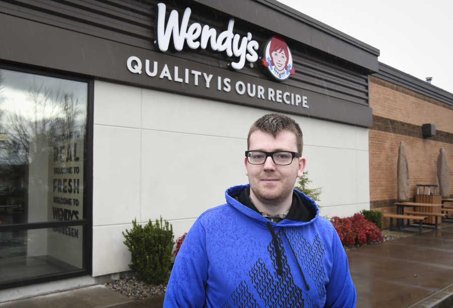 Dennis Jeppson, 18, of Orchards, stands outside the Wendy&#039;s where he works. He receives a wage bump Jan. 1 to $11 per hour, due to the passage of Initiative 1433 in November.