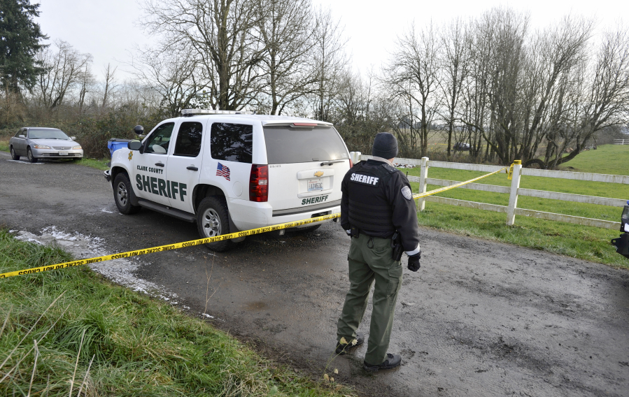 Clark County sheriff's Deputy Dan Perritt protects the perimeter around an officer-involved homicide investigation Sunday in the Ridgefield area. Police say a deputy shot and killed an armed man who allegedly trespassed on a homeowner&#039;s property Sunday morning.