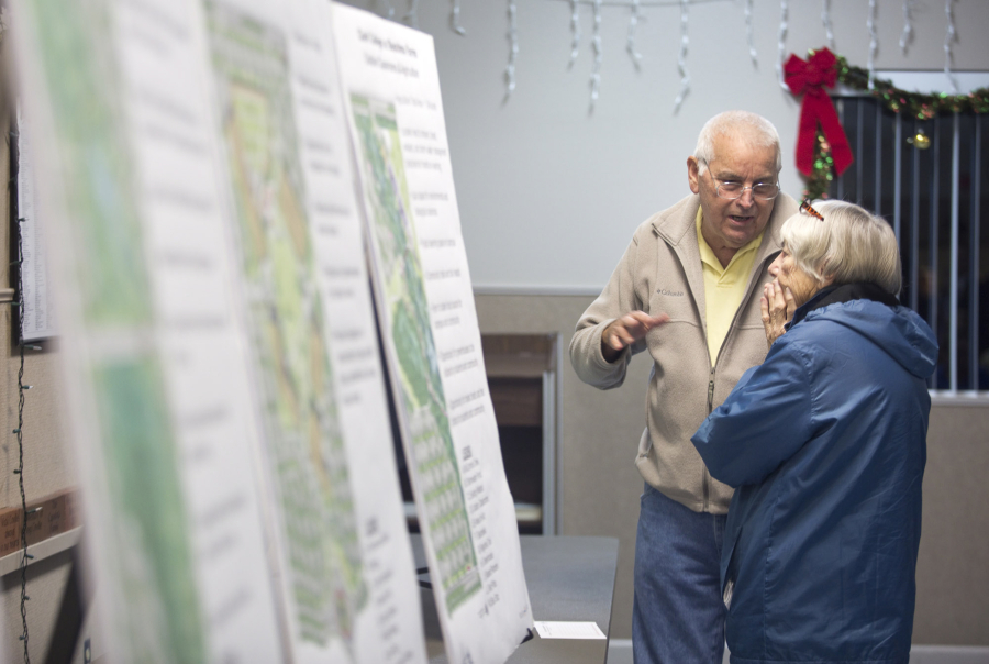 Gerald Jones and his neighbor Barbara Staudacher look at plans for a new Clark County campus in east Ridgefield. The college presented the final master plan for the new campus Monday at the Ridgefield Community Center.