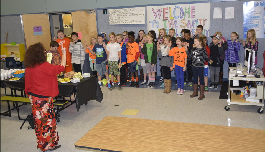 Washougal: Gause Elementary School fourth- and fifth-graders take their oath to serve as new members of the School Safety Patrol, where they will help fellow students navigate the crosswalk near the school.