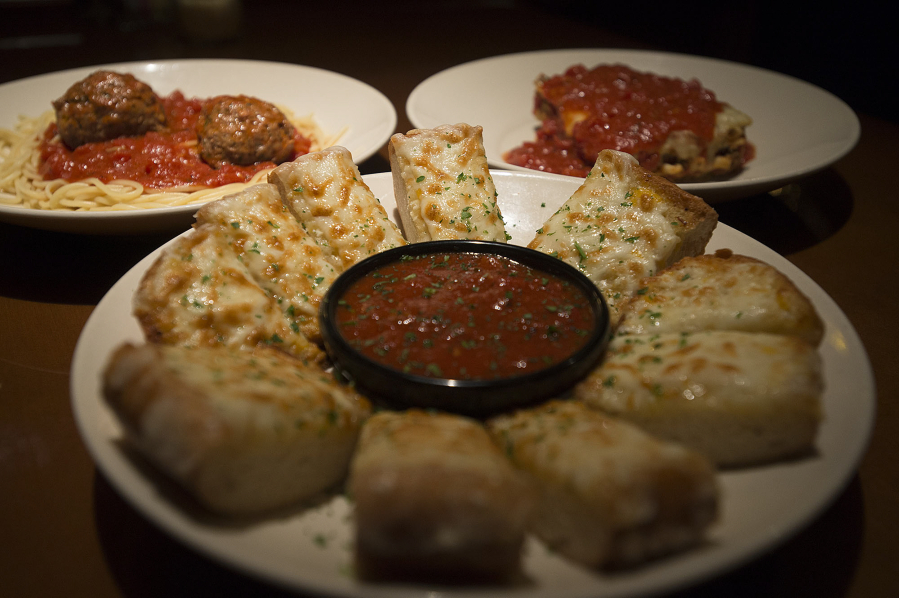 Sicilian garlic cheese bread, foreground, is served Dec. 22 with Sicilian meatballs, left, and baked lasagna at The Old Spaghetti Factory in Vancouver.