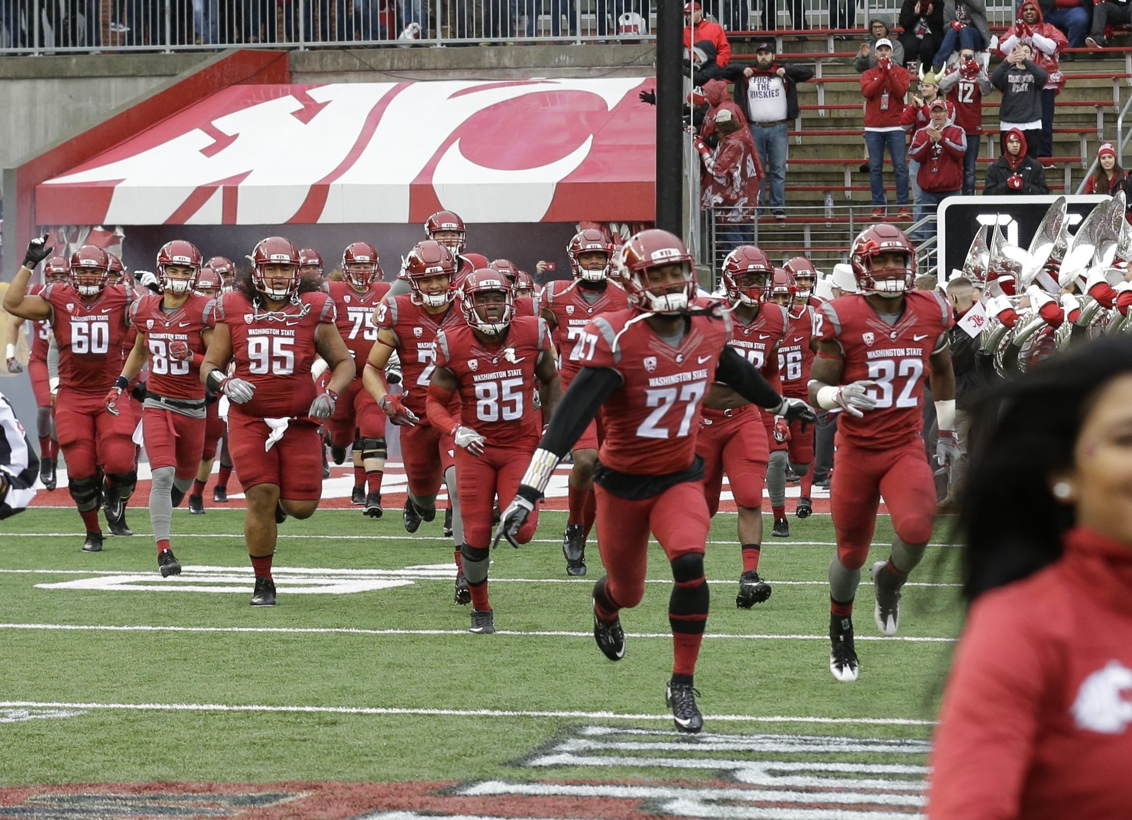 Washington State players run onto the field before an NCAA college football game against Washington, Friday, Nov. 25, 2016, in Pullman, Wash. (AP Photo/Ted S.