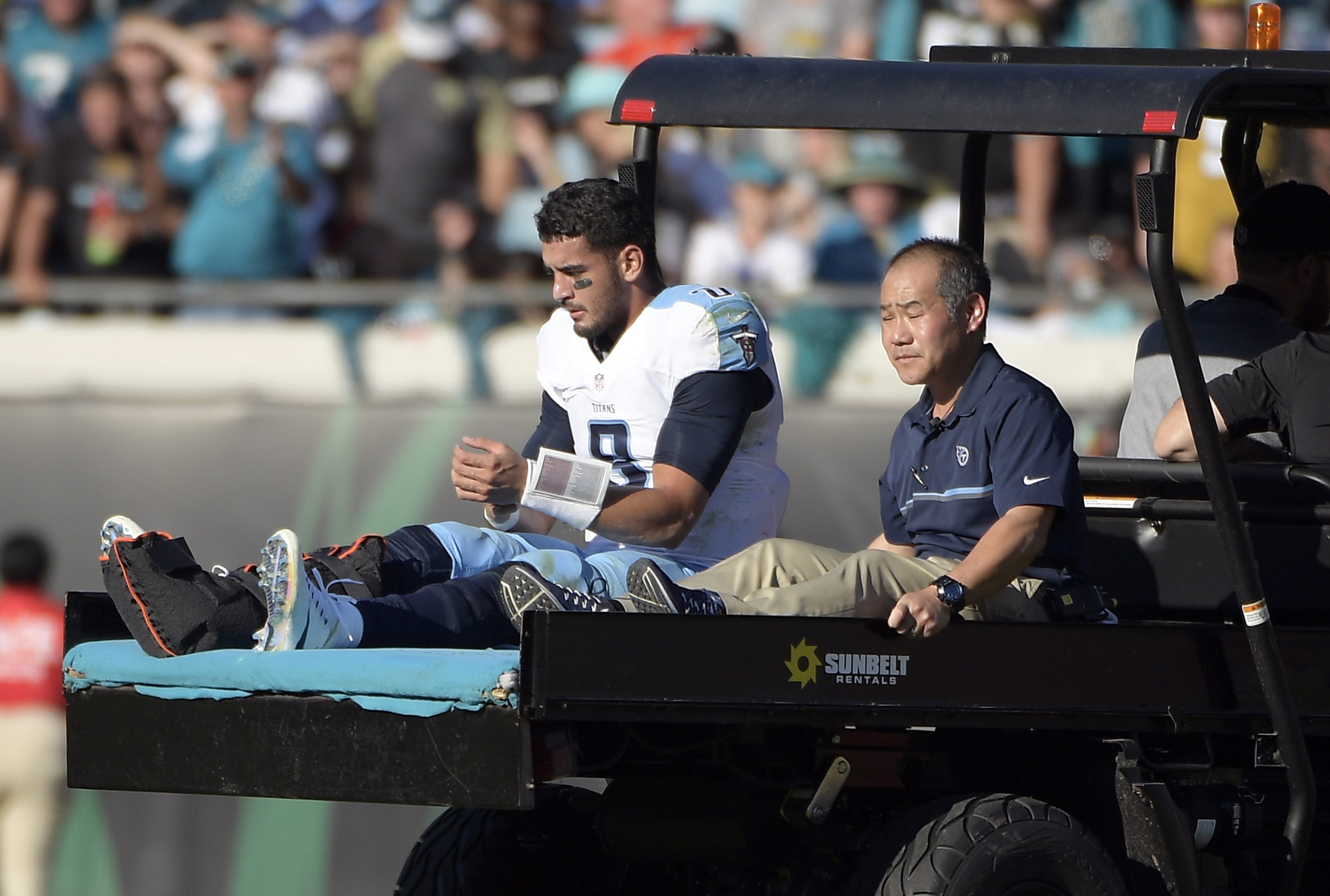 Tennessee Titans quarterback Marcus Mariota leaves the field on a cart after he was injured during the second half of an NFL football game against the Jacksonville Jaguars, Saturday, Dec. 24, 2016, in Jacksonville, Fla. (AP Photo/Phelan M.