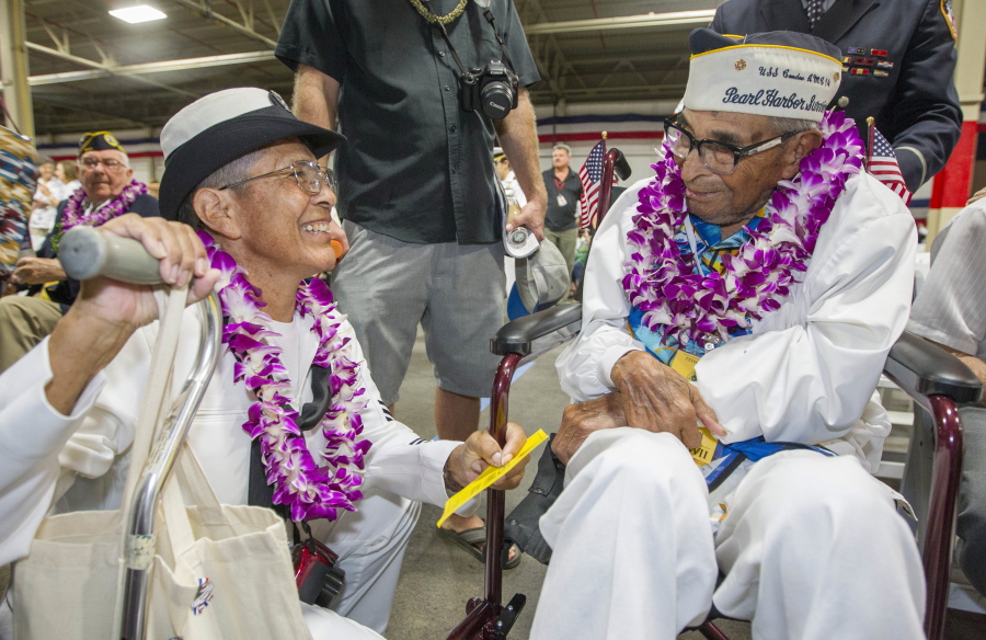 Kathleen Chavez, left, talks with her father, Ray Chavez, 104, of the USS Condor, on Wednesday at the World War II Valor in the Pacific National Monument at Joint Base Pearl Harbor-Hickam in Honolulu. Ray Chavez is the believed to be the oldest living survivor of the Pearl Harbor attack.