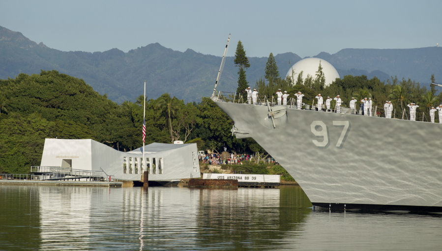 The USS Halsey passes before the USS Arizona Memorial during a moment of silence at Joint Base Pearl Harbor-Hickam, Wednesday, in Honolulu. Survivors of the Japanese attack, dignitaries and ordinary citizens attended a ceremony at Kilo Pier to commemorate the 75th anniversary of the Japanese attack on the naval harbor.