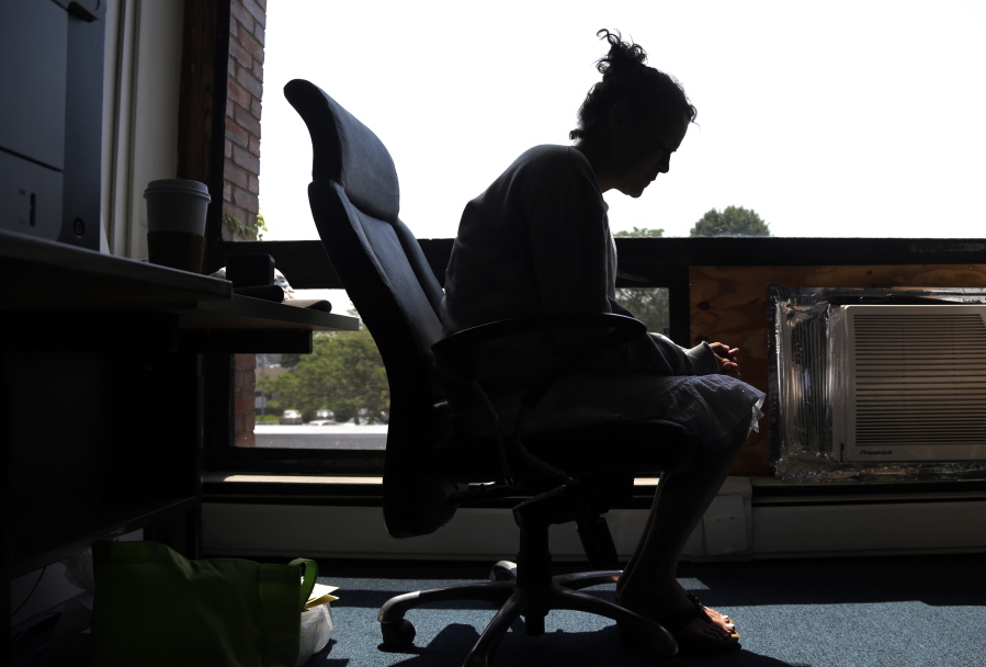 A woman speaks to The Associated Press inside a police station in Gloucester, Mass., in 2015. She voluntarily came to the police for help with her heroin addiction.