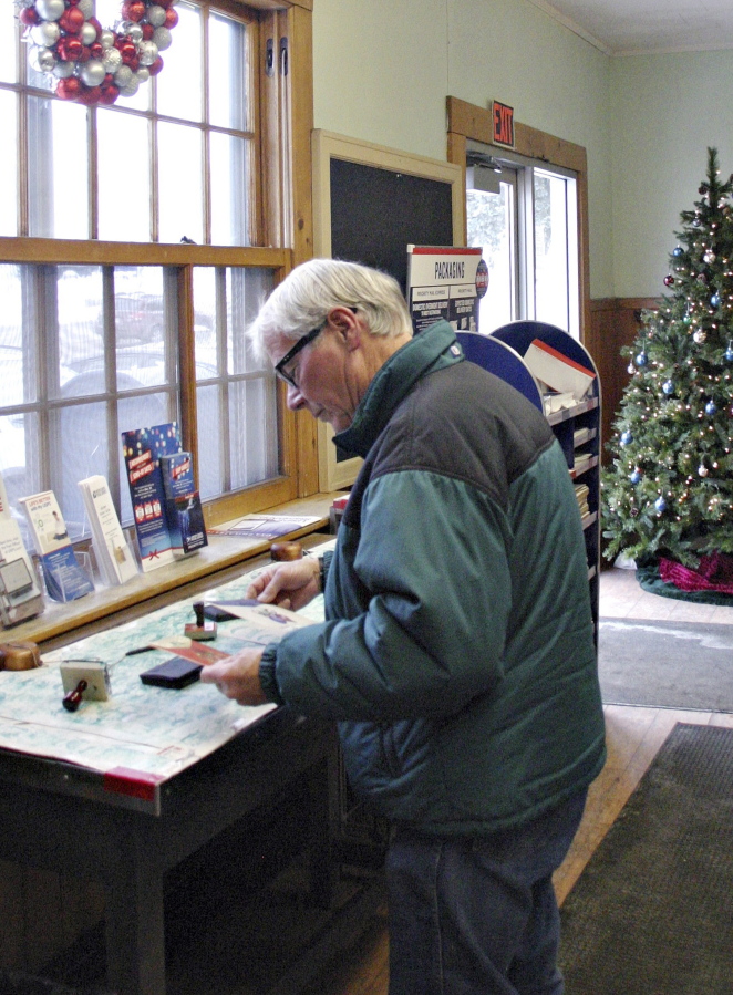 Larry Steigleman of Littleton, N.H., handles mail Dec. 20 at the post office in Bethlehem, N.H. On the counter, rubber stamps and ink pads are provided where patrons can mark their cards and packages with a 2-inch-square wooded scene that says &quot;Bethlehem, New Hampshire.&quot; The tiny town in the White Mountains is one of the post offices in the United States with Christmas or holiday-themed names.