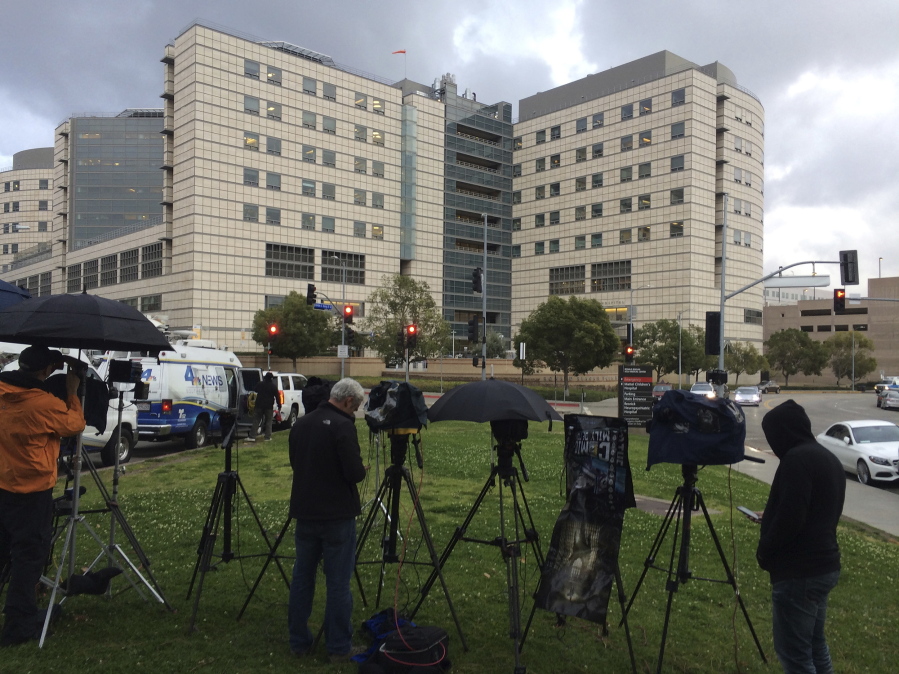 Television crews stand under the rain Friday outside the Ronald Reagan UCLA Medical Center in Los Angeles, where actress Carrie Fisher was reportedly transported after suffering a severe medical emergency on a flight from London to Los Angeles.