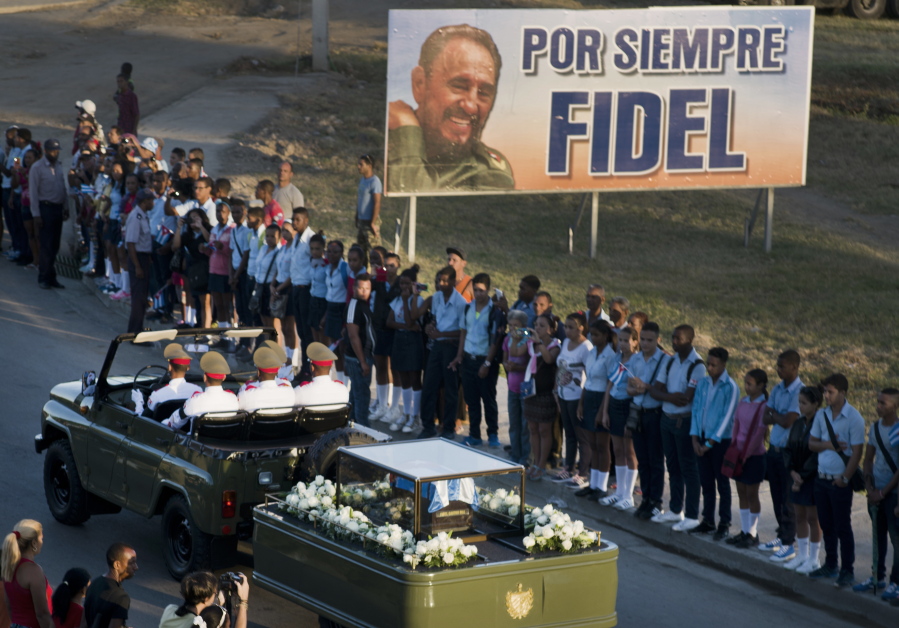 The motorcade carrying the ashes of the late Cuban leader Fidel Castro makes its final journey toward the Santa Ifigenia cemetery Sunday in Santiago, Cuba.