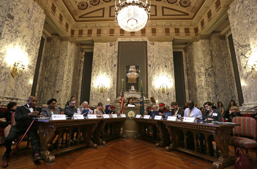 Electors fill out their ballots during a meeting of Washington state&#039;s Electoral College on Monday in Olympia.