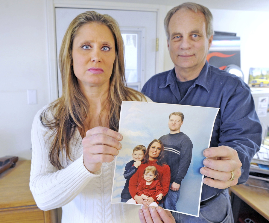 Joel Melom&#039;s ex-wife, Dana Linderman, and stepfather, Tim McCray, hold a photo of Melom with his family while he still married to Linderman. Melom&#039;s family is upset about a fake news story that was posted about the circumstances of his death in February.