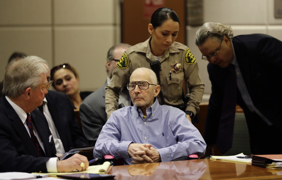 Real estate heir Robert Durst, center, is brought into a courtroom in a wheelchair for a hearing Wednesday in Los Angeles. (JAE C.