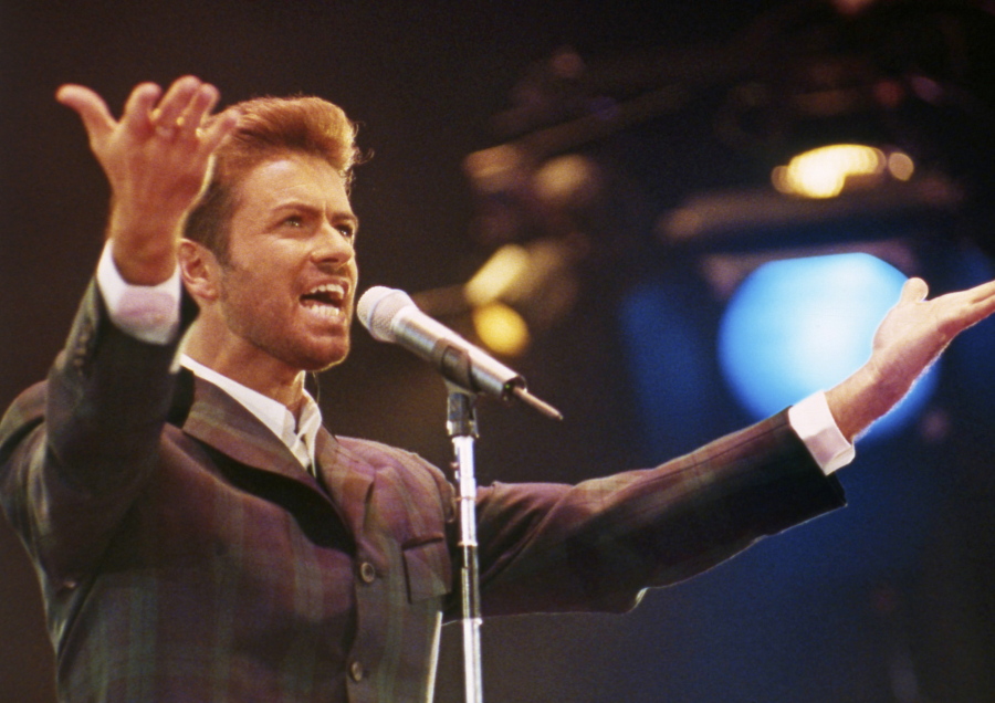 George Michael performs Dec. 2, 1993, at &quot;Concert of Hope&quot; to mark World AIDS Day at London&#039;s Wembley Arena. The singer died Christmas Day at the age of 53.