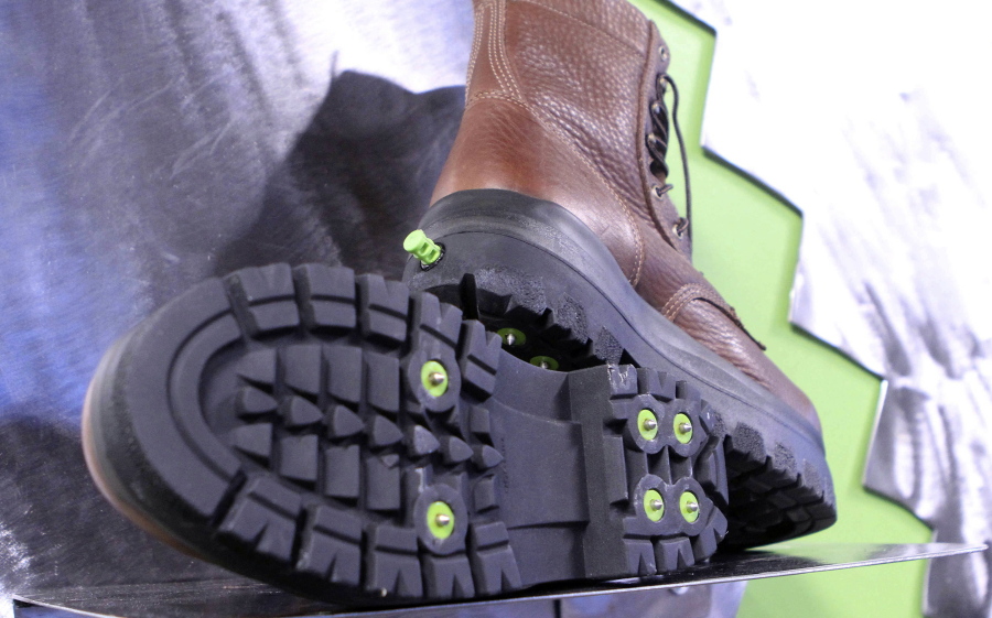 A display shows the bottom and back of boots Nov. 10 at the KickSpike store in Anchorage, Alaska. Activate the green button on the back of the boot heel and 7mm steel cleats pop out. Kick the button again and the cleats retract, allowing the wearer to walk inside without tearing up floors. The boots are a new option for walking safely in Anchorage, where ice can be found on streets up to seven months per year.