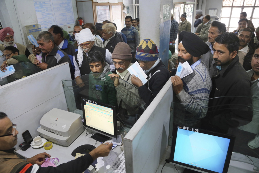 People line up to deposit discontinued notes in a bank Friday in the Samba district of Jammu and Kashmir, India. Friday was deadline for depositing old 500- and 1,000-rupee notes.