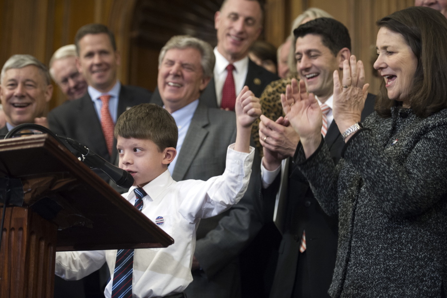 Rep. Fred Upton, R-Mich., left, House Speaker Paul Ryan, of Wis., and Rep. Diana DeGette, D- Co., right, join other members of Congress as they applaud Max Schill, 7, while he speaks on Capitol Hill in Washington,on Thursday during the signing ceremony for the 21st Century Cures Act. Schill suffers from Noonan Syndrome.